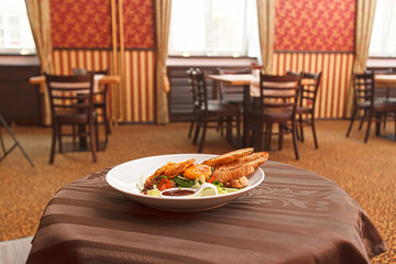 Potato pancakes with vegetable salad and homemade bread.