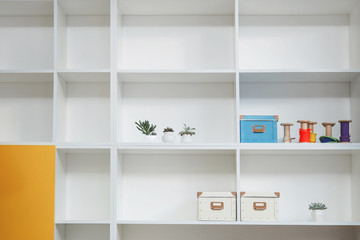 Fototapeta na wymiar Empty shelves in white wooden rack