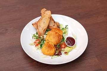 Potato pancakes with vegetable salad and homemade bread.