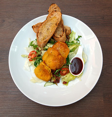 Potato pancakes with vegetable salad and homemade bread.