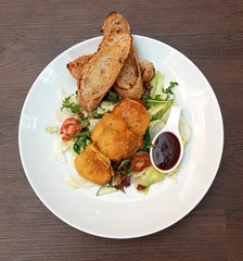 Potato pancakes with vegetable salad and homemade bread.