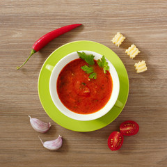 Tomato soup gazpacho in a green cup. Top view