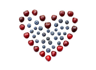 Isolated heart of cherry and blueberry on a white background
