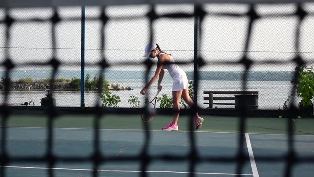 Tennis player in action. Cam moves up. Slow motion