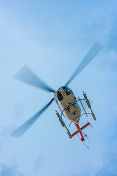 helicopter flying above with propeller blades blurred by fast mo