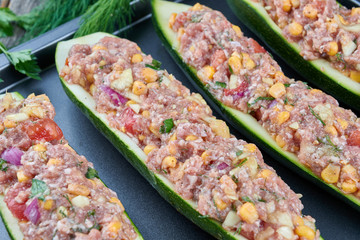 Raw courgettes stuffed with meat and vegetables