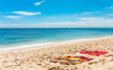 Fototapeta na wymiar Two towels on a tropical sandy beach.
