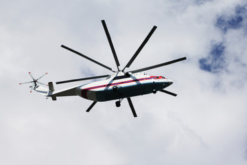 White and red rescue helicopter flying in the sky