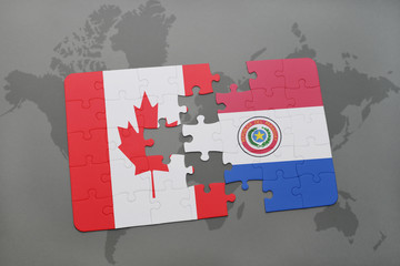 puzzle with the national flag of canada and paraguay on a world map background.