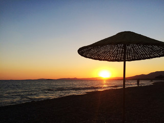 Silhouettes of sun umbrellas