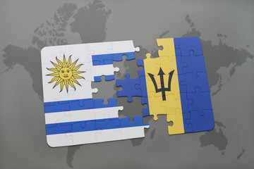 puzzle with the national flag of uruguay and barbados on a world map background.