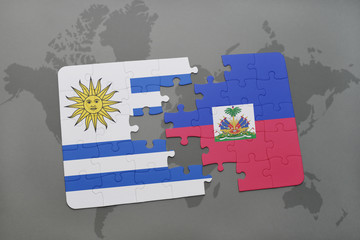 puzzle with the national flag of uruguay and haiti on a world map background.
