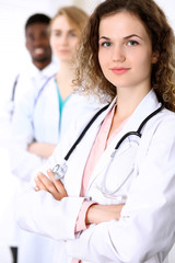 Fototapeta premium Happy doctor woman with medical staff at the hospital