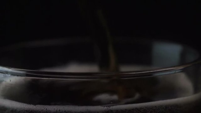 Closeup shot of a soda being poured into a glass