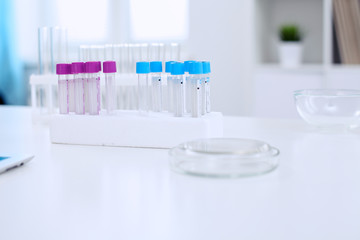Research laboratory working space. Test tubes and tablet PC are lying at the table. Medical equipment. Blood test
