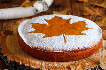 Homemade tasty manna pie  with a sugar powder (stencil of a mapl