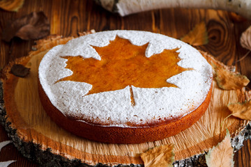 Homemade tasty manna pie  with a sugar powder (stencil of a mapl