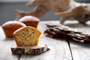 Homemade healthy muffin with poppy seed on a wooden background. Selective focus