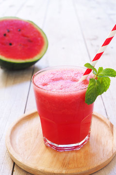 Close up of watermelon smoothie on a wooden plate.