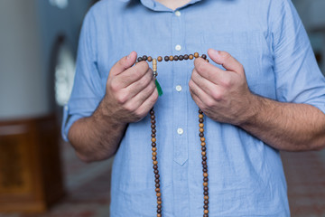 hand holding a muslim rosary