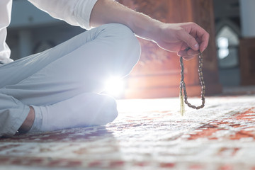 hand holding a muslim rosary