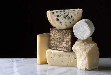 Cheeses arranged on a marble table