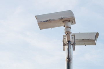 Outdoor security CCTV camera on blue sky background