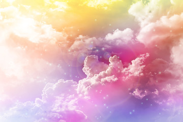 Colourful dreamy puffy clouds sky with lense flare