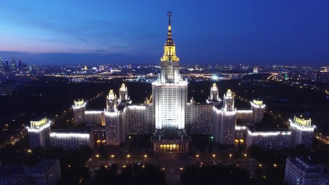 Beautiful evening shot of MSU Moscow State University. Unique night Aerial drone footage. Flight near spire and star, high altitude. Illumination. Stalin skyscraper.
