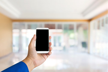 Business women hand smartphone or mobile phone on home office background