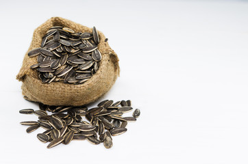 A sunflower seeds in small sack bag on white background