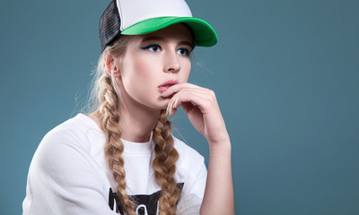 Sports beautiful girl in sport hat and white sweatshirt
