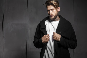Handsome man in white t-shirt on grey background