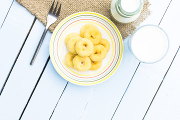 Donut dessert and milk bottle and milk glass on wooden sky blue table.Meal or breakfast hi-vitamin and calcium