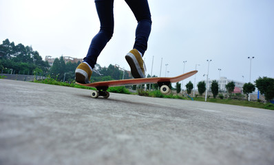skateboarder legs riding on a skateboard