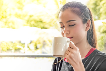 Woman drinking coffee at coffee cafe