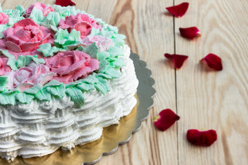 Delicious creamy cake basket of roses (half cake) on  wooden table