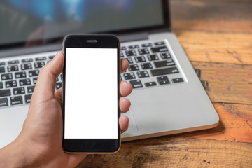 Close up of a man using smart phone with blank mobile and cup of