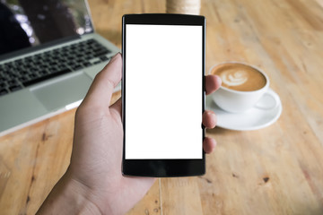 Close up of a man using smart phone with blank mobile and cup of
