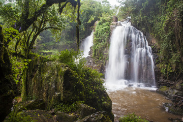 Fototapeta na wymiar The Horse Shoe waterfall amid lush tropical forest vegetation