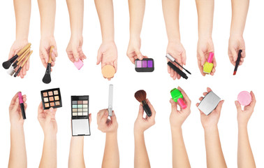 Fototapeta premium set of makeup cosmetics and brushes in a hands isolated on white