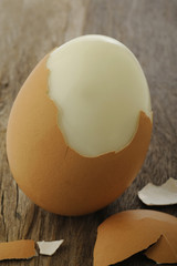 Egg boiled on old wooden background