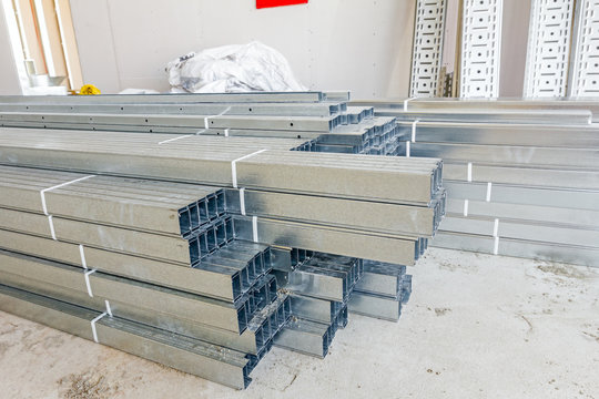 Thin square metal profiles for dry wall stacked on ground