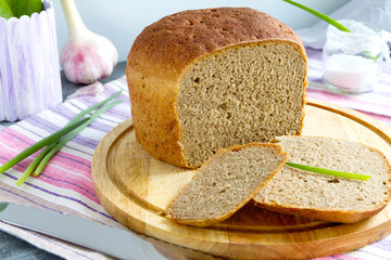 Cutting rye-wheat bread.  Selective focus
