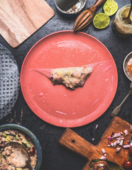 Homemade summer rolls with canned tuna fish filling, step by step wrapping on rustic kitchen table with plates, tolls and ingredients, top view