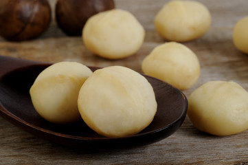 macadamia nuts in wooden spoon