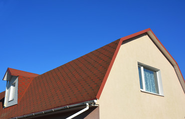 Exterior House Attic Dormer Window and Roofing Construction. Gable roof and dormer type of roof.