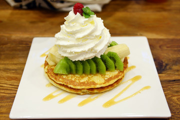 Pancakes with fresh giwi,banana and whipcream for breakfast
