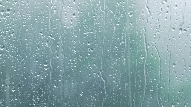 heavy rain on window glass background focus on right side