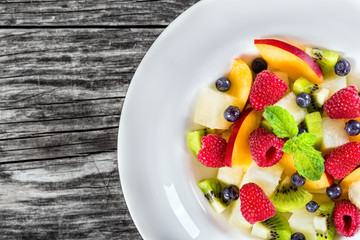 delicious fruit  and berry summer salad decorated with mint leav